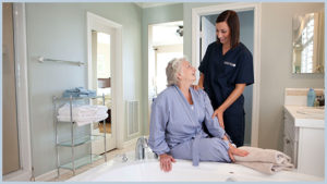 caregiver helping old lady in wheelchair