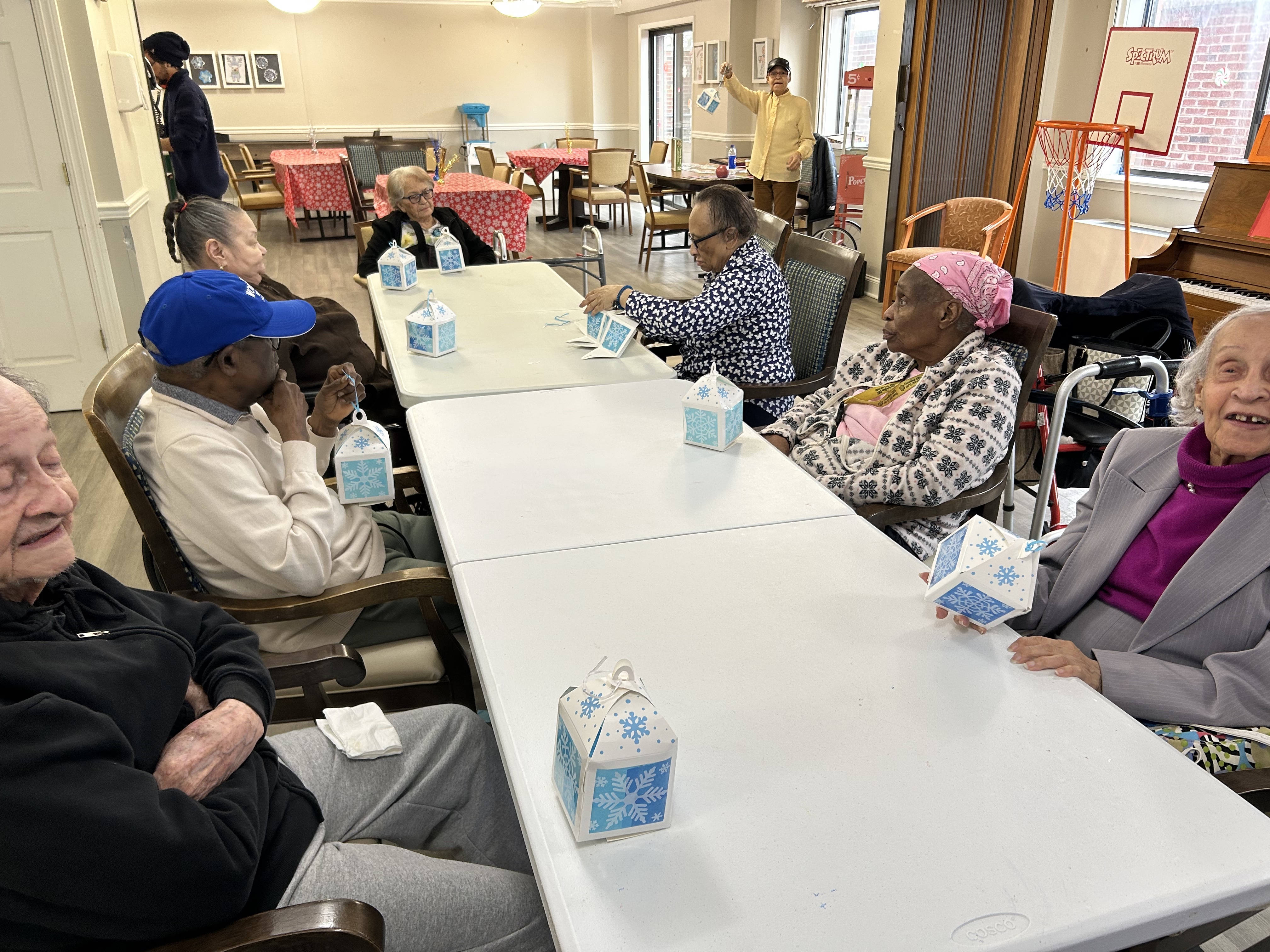 Senior residents at Harbour View Senior Living in North Bergen, NJ creating colorful paper lanterns together during an arts and crafts activity.