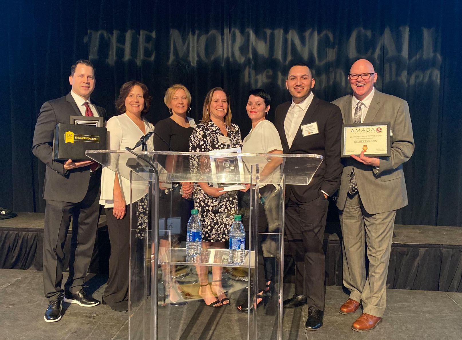 awards ceremony lehigh valley 2 A group of people in formal attire smile as they hold up their awards at a gala ceremony