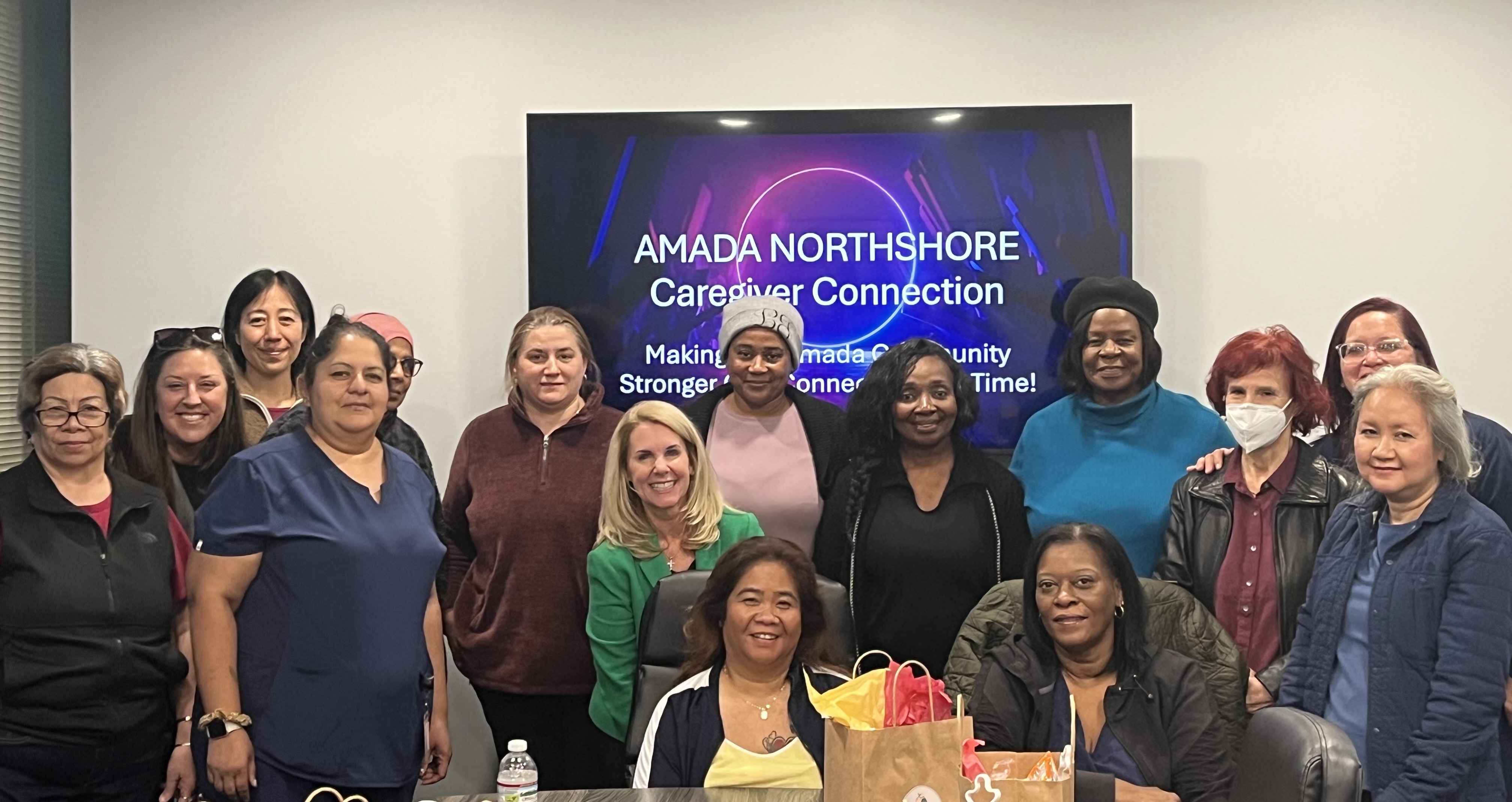 Group of Amada NorthShore caregivers gathered together at Caregiver Connection event.