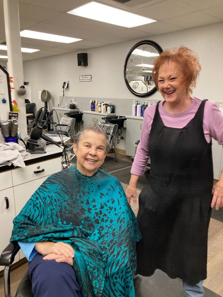 Two elderly ladies enjoying themselves at the salon.