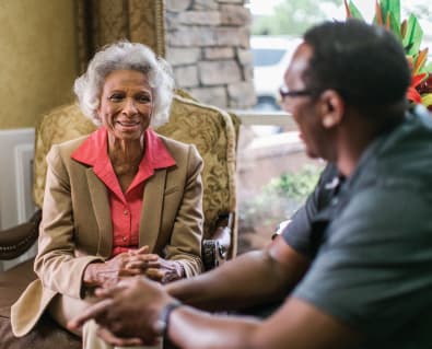 An elderly woman having conversation with a man