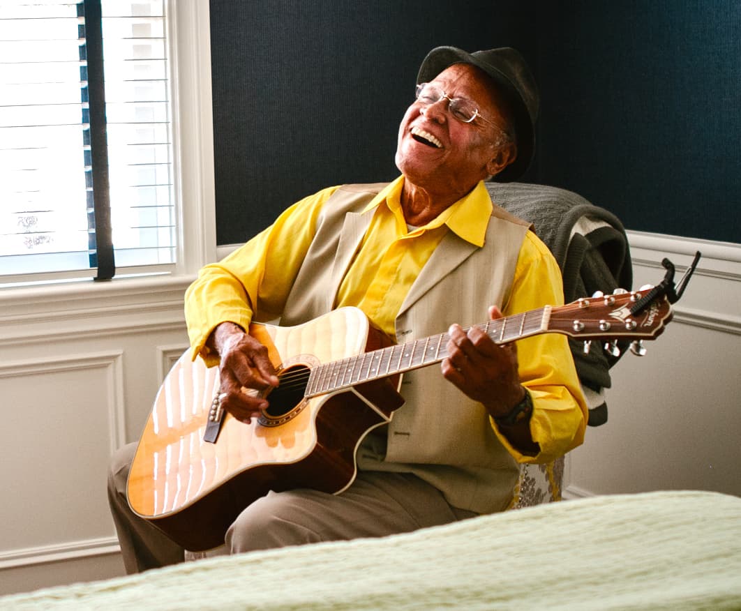 senior man playing guitar